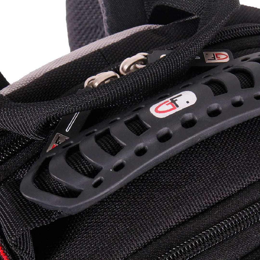 Close-up of a black camera gear bag showing a textured black webbing zipper, silver metal zipper pulls, and a black plastic ventilation-style handle with a red and white logo.