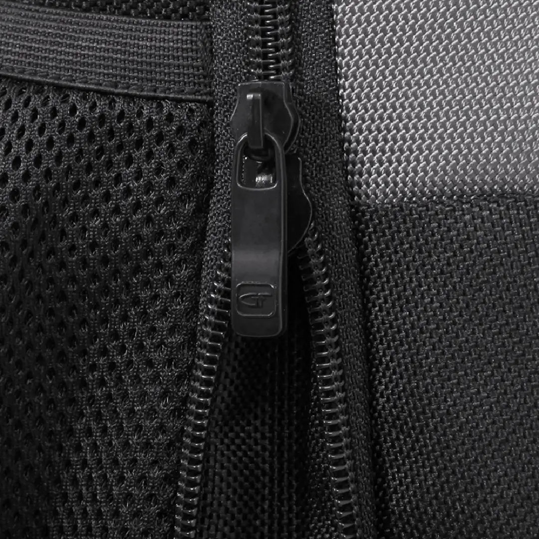 Close-up of a black zipper pull with an embossed 'GF' logo, showing black mesh fabric and textured woven material on either side.