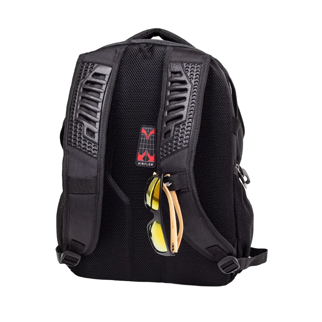 Black mesh backpack shown from the back, featuring textured black shoulder straps, a red and black logo patch, and a side pocket holding yellow-tinted sunglasses, on a white background.