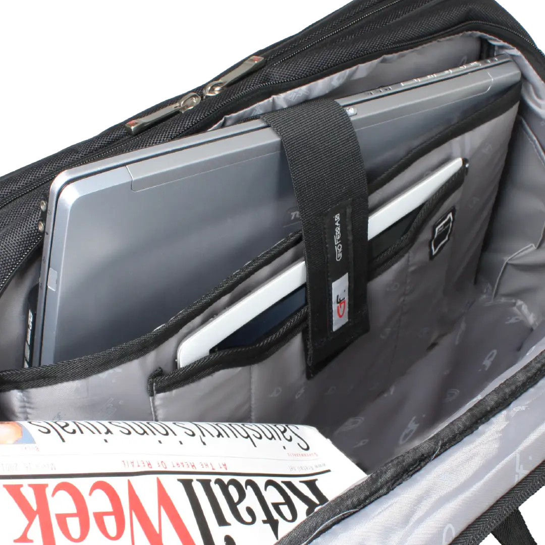 Open black and gray laptop backpack showing interior compartments, a silver laptop, a white tablet, and a magazine inside.