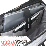 Open black and gray laptop backpack showing interior compartments, a silver laptop, a white tablet, and a magazine inside.