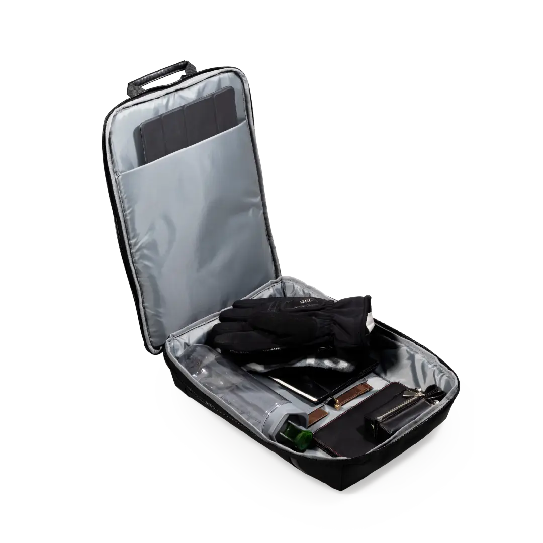 An open black and silver travel organizer bag with a telescoping handle, shown on a white background. Inside, a black glove and other travel accessories are neatly packed.