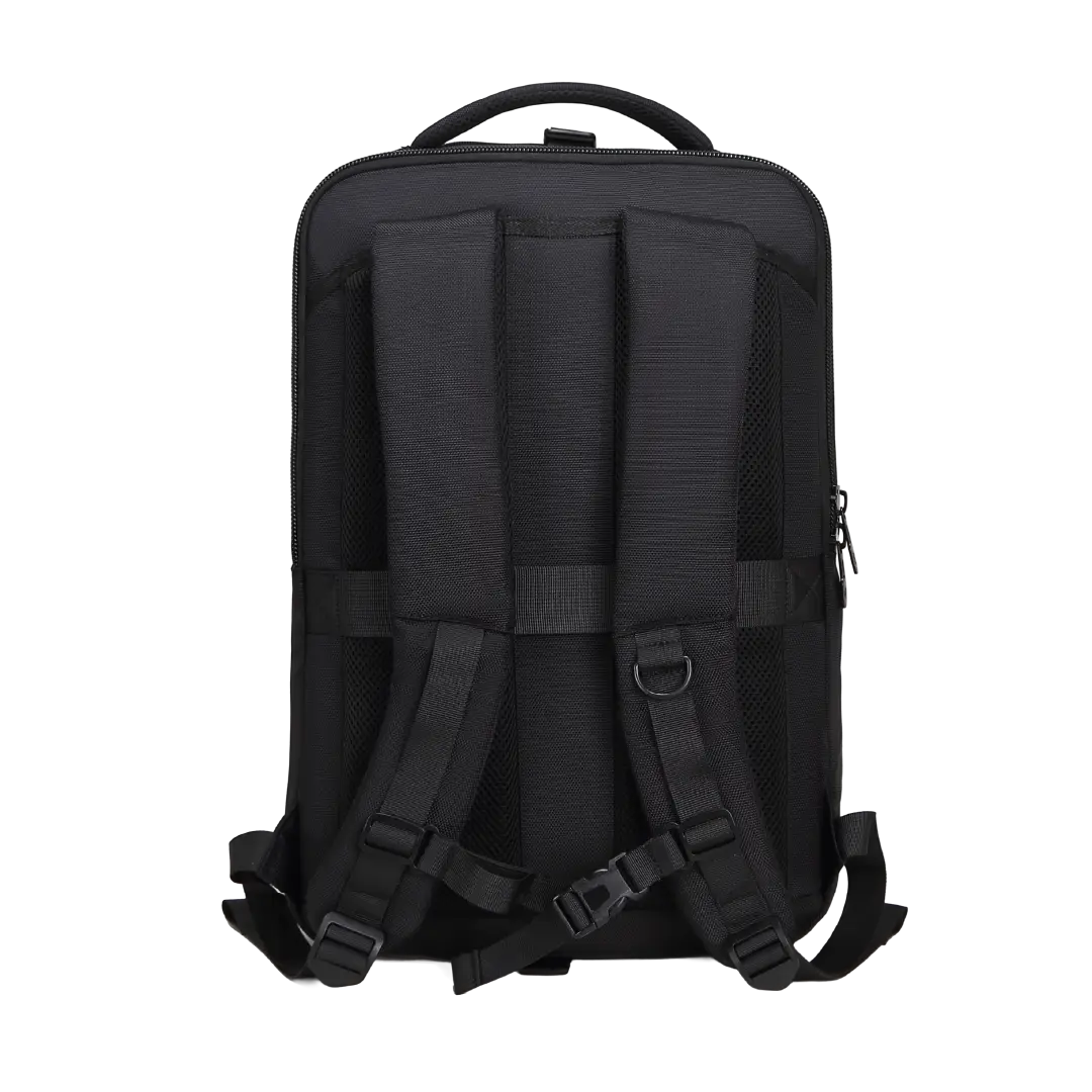 The back view of a black backpack, showing padded shoulder straps, compression buckles, a top carry handle, and a zippered side pocket, isolated on a white background.