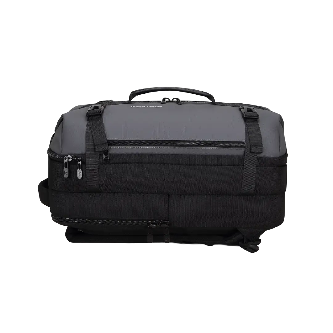 A dark gray and black soft-sided duffel bag with a top carry handle, multiple zippered compartments, and side compression straps, shown on a plain white background.