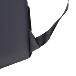 Close-up of a black textured bag with a black webbing strap attached, shown on a plain white background.