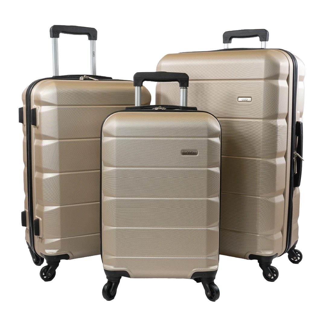 Three-piece champagne hardshell spinner luggage set with black trim and handles, shown on a plain white background.