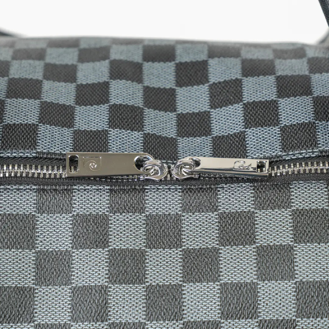 Close-up of a checkered pattern with a zipper on a gray background