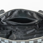 Black handbag with a visible brand logo on a white background