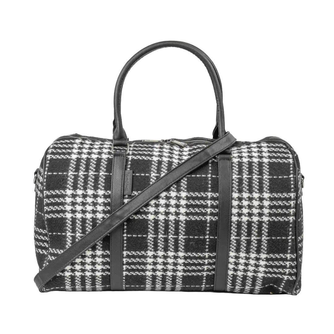 Black and white plaid handbag with a shoulder strap on a white background