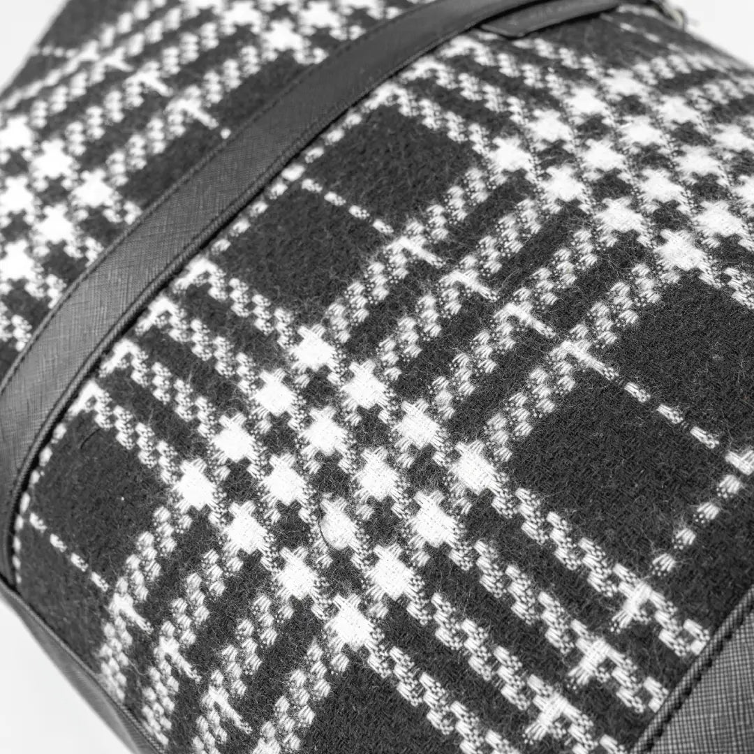 Close-up of a black and white checkered fabric with a strap