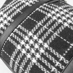 Close-up of a black and white checkered fabric with a strap