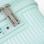 Light blue suitcase with 'Pierre Cardin' branding on a white background