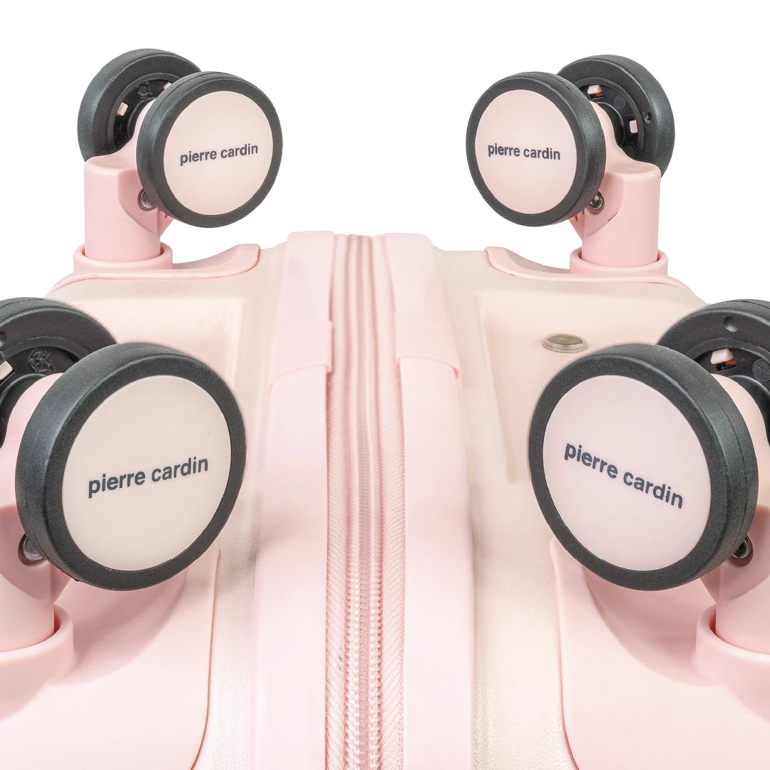 Pink suitcase with 'Pierre Cardin' wheels on a white background