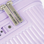 Close-up of a purple suitcase with 'Pierre Cardin' branding on a white background