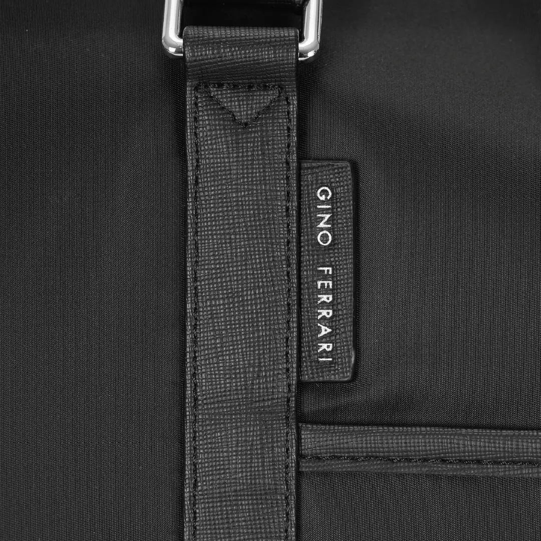 Close-up of a black bag with a visible 'Gino Ferrari' brand label.