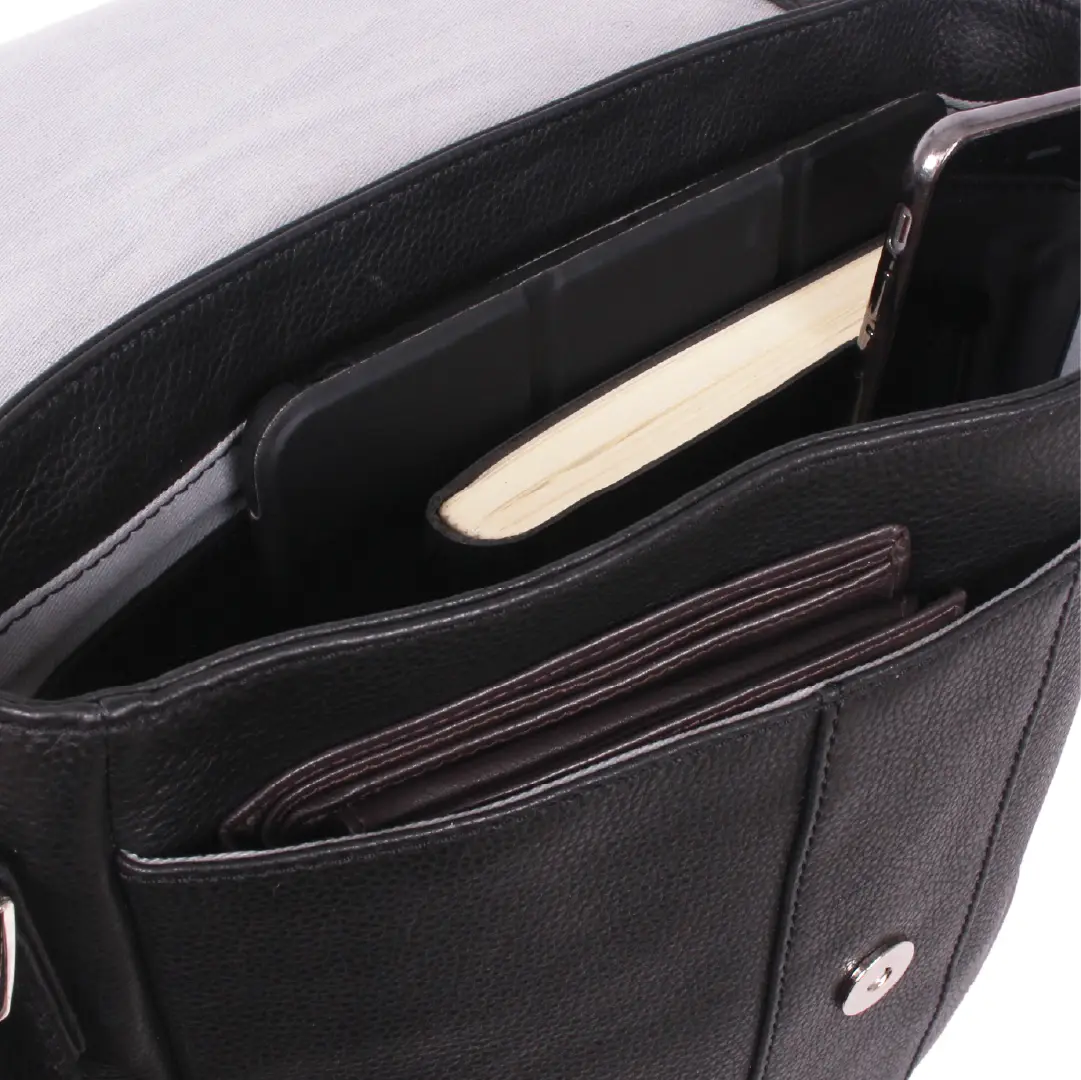 Close-up of the interior compartments of a black leather bag, showing card slots, a notebook, and a smartphone pocket.
