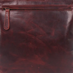 A dark reddish-brown leather crossbody bag with a front zippered pocket and a top flap, shown against a plain white background.