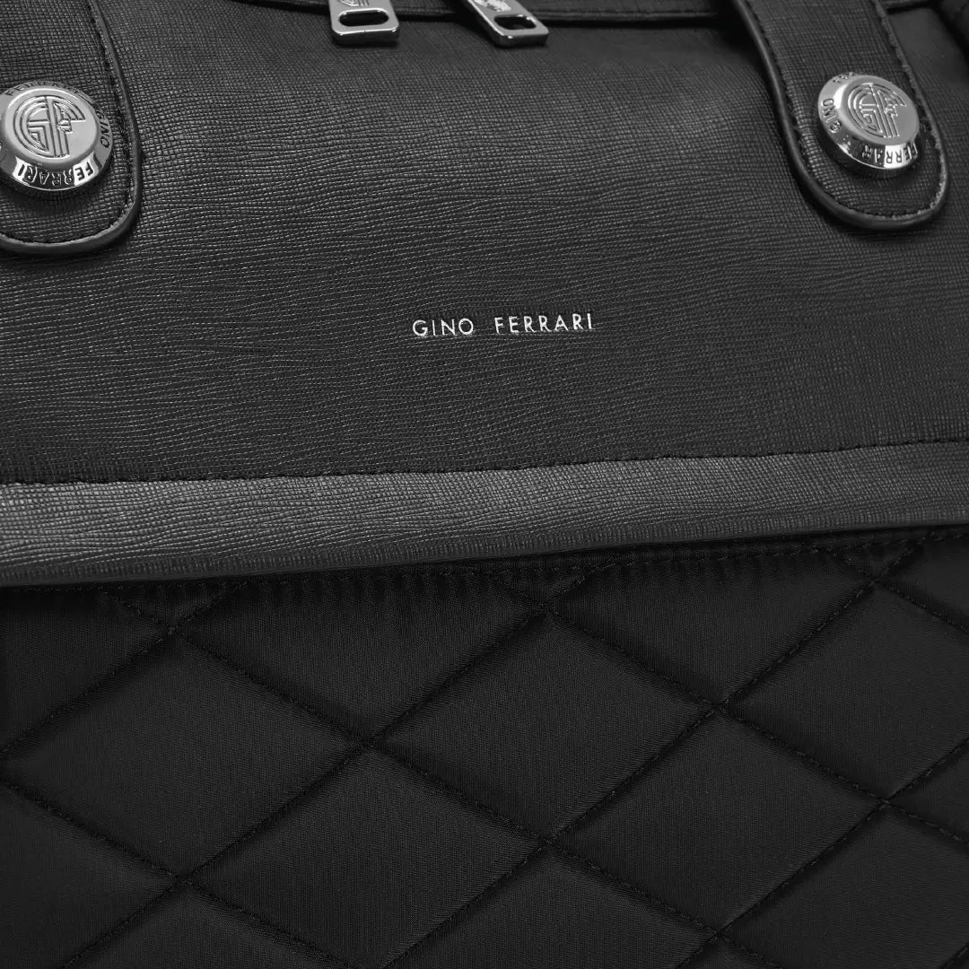 Close-up of a black bag with 'Gino Ferrari' branding on a dark background