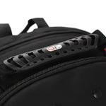 Close-up of a black backpack showing a textured black plastic handle attachment with a small red and white logo, zipper details, and a black fabric body against a white background.