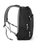 A black and gray backpack shown from the side against a plain white background, featuring multiple zippered compartments and padded shoulder straps.