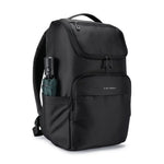 A black backpack with multiple zippered compartments and a side pocket holding a folded umbrella, shown on a plain white background.