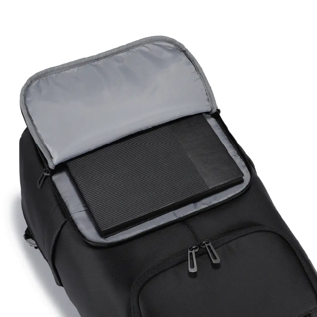 A black backpack shown open, revealing a grey interior lining and a padded compartment inside.