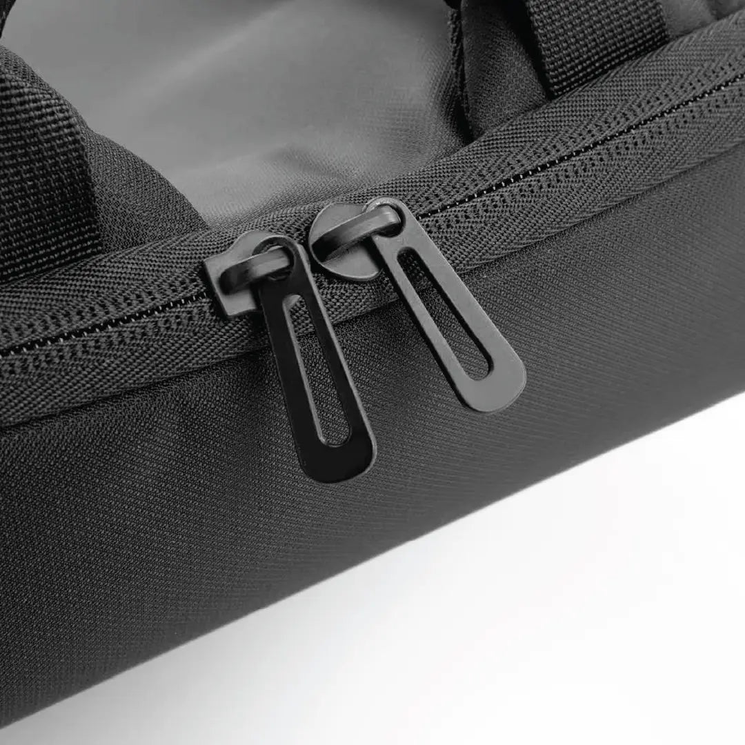 Close-up of a black backpack with zippers on a white background