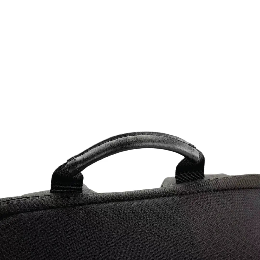 Close-up of a black textured fabric bag with a padded top handle on a plain white background.