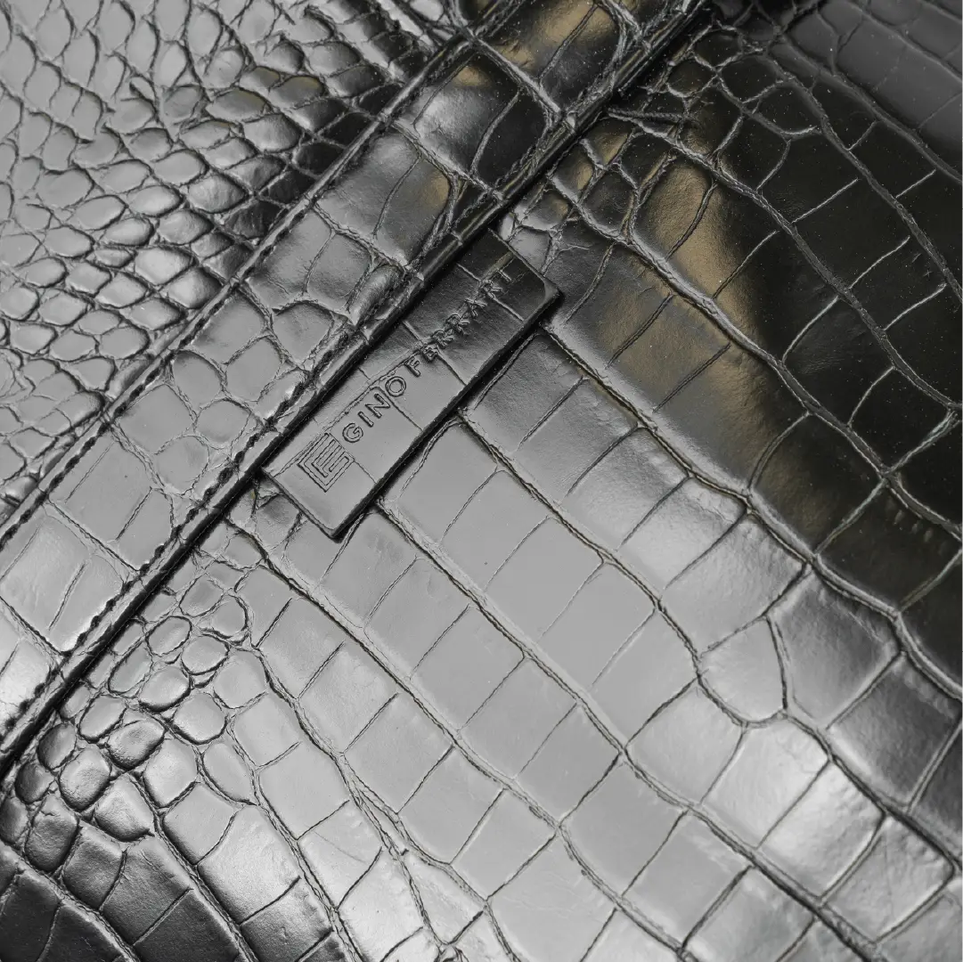 Leather-look textured bag with minimal branding on it.