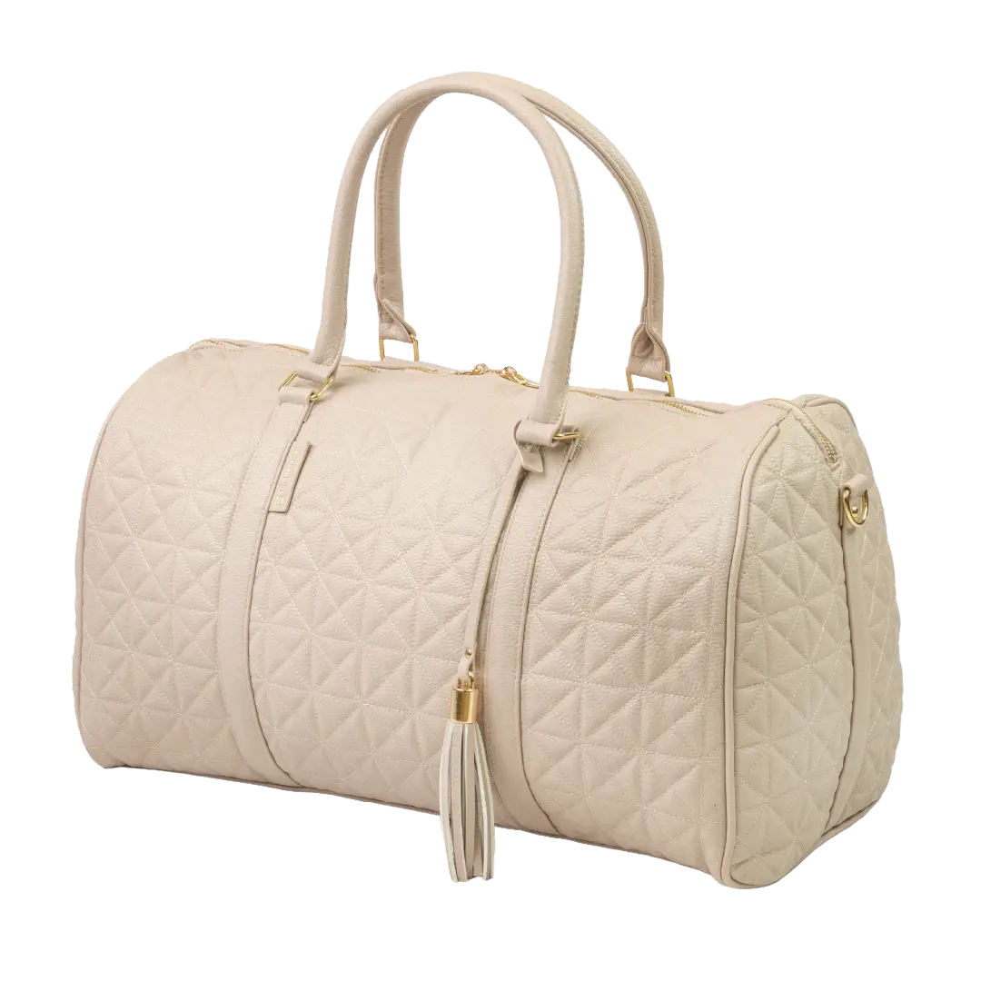 A close-up of a beige bag with patterned stitching, a gold zip and gold accents.