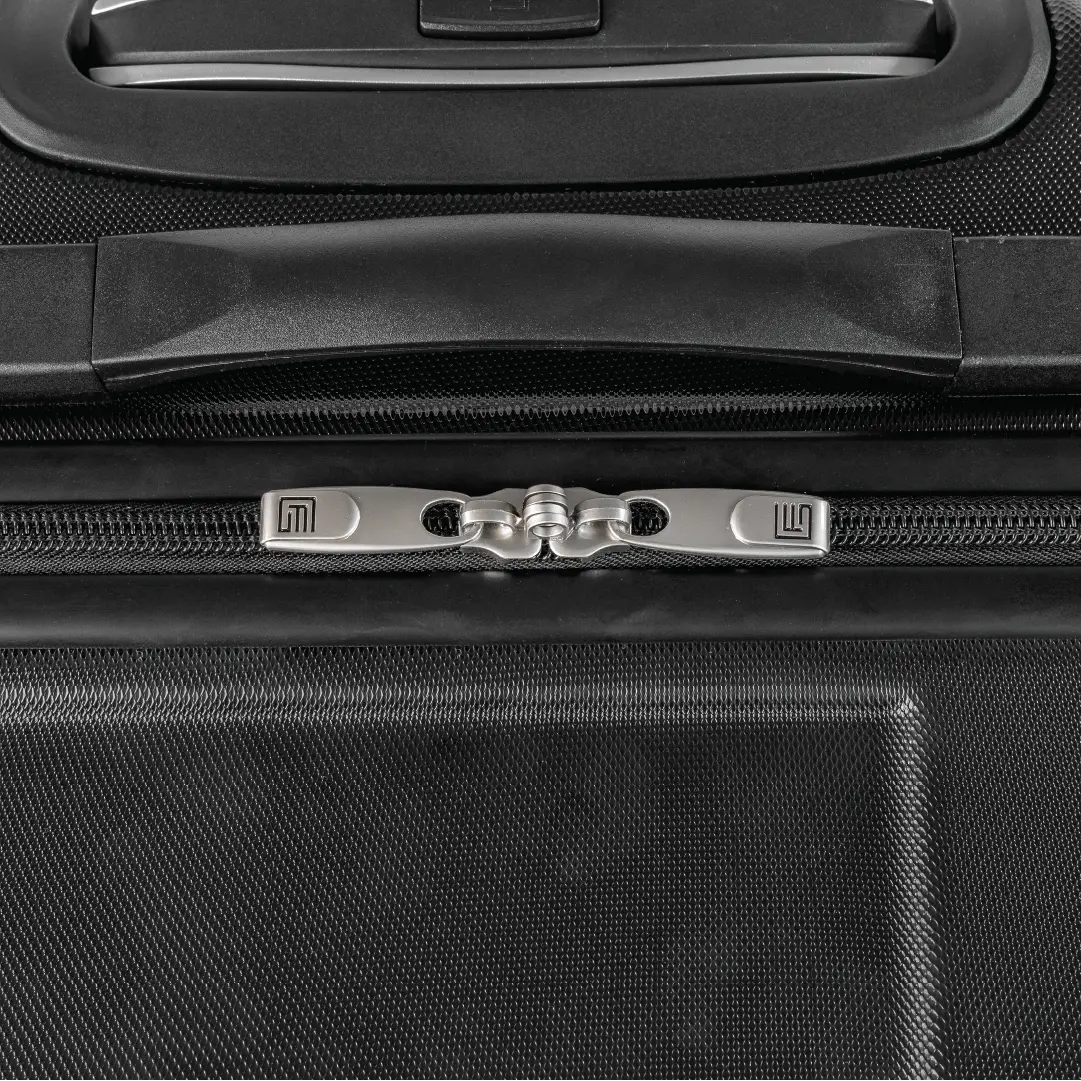 Close-up of a black suitcase zipper and handle area