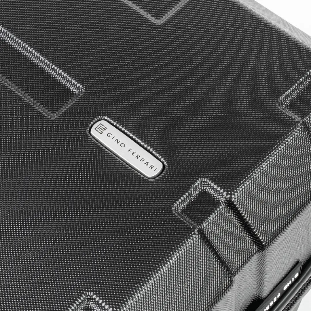 Close-up of a textured black surface with a brand logo in the center.