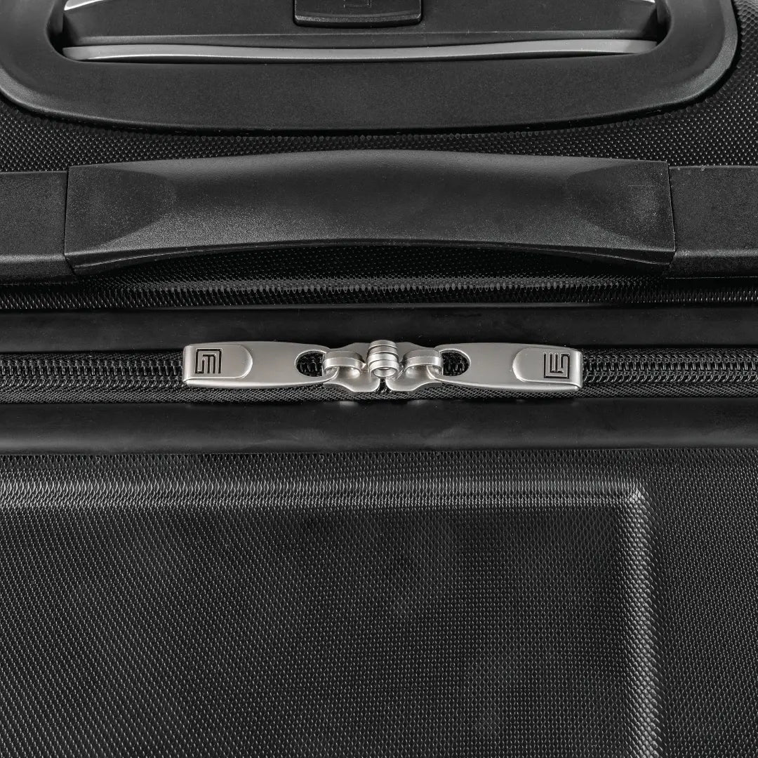 Closeup of a black suitcase showing a handle and the zip.
