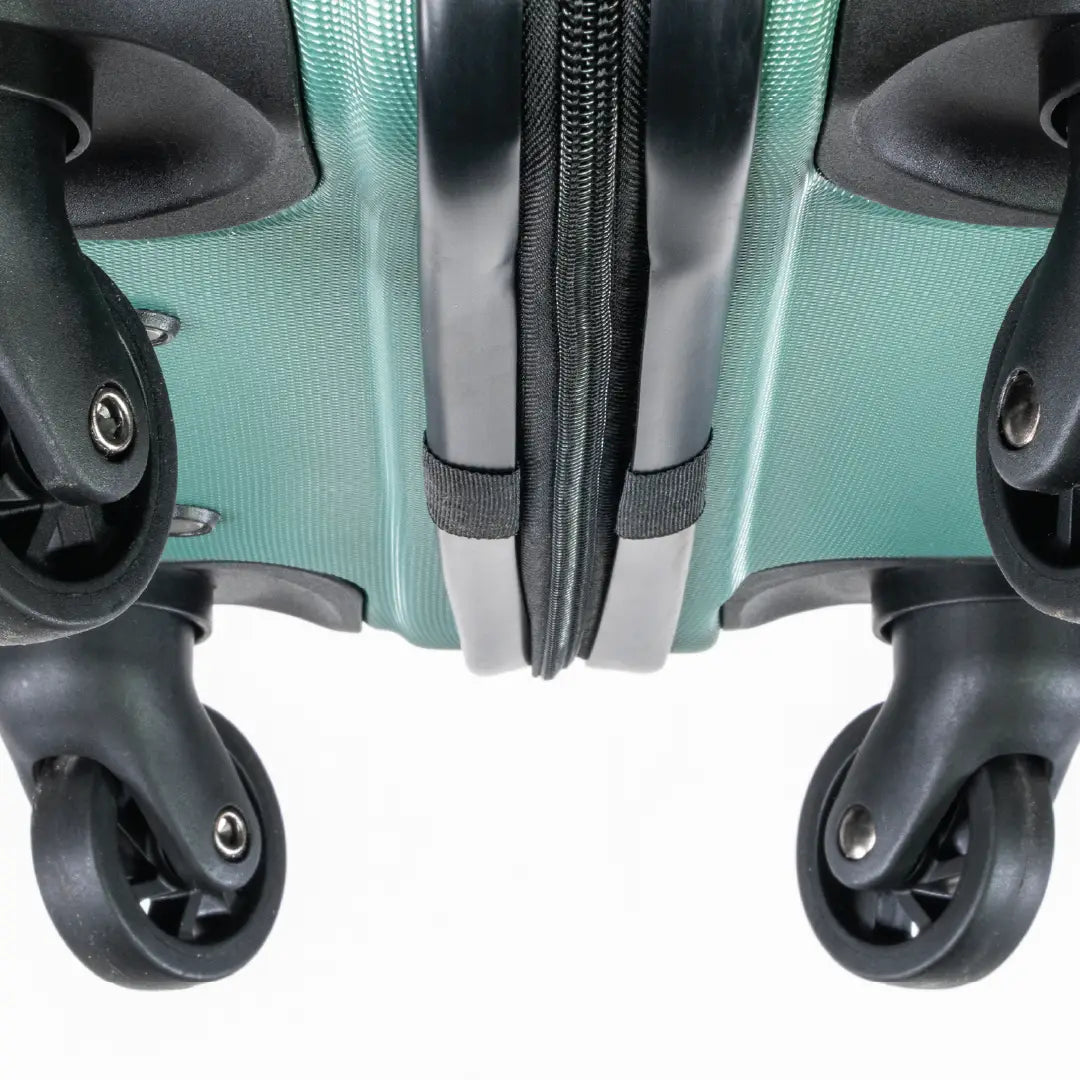 Close-up of a teal suitcase with wheels and zippers on a white background
