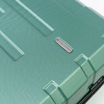 Teal textured suitcase with a brand logo on a white background