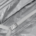 Close-up of a suitcase with a strap and visible branding.