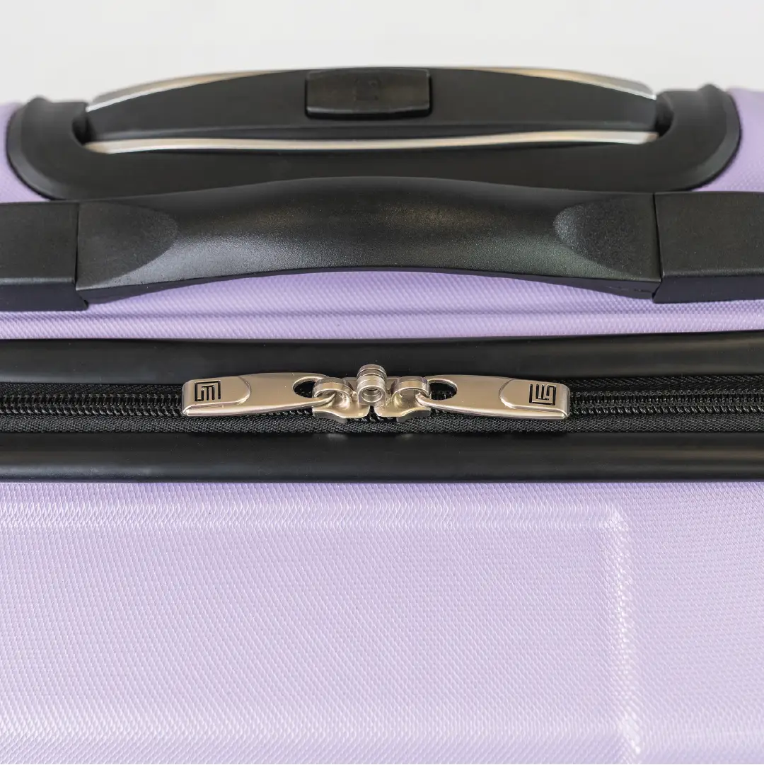 Close-up of a purple suitcase with a black handle on a white background 