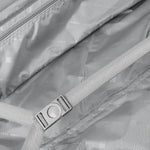 Close-up of a suitcase with a strap for holding luggage securely.