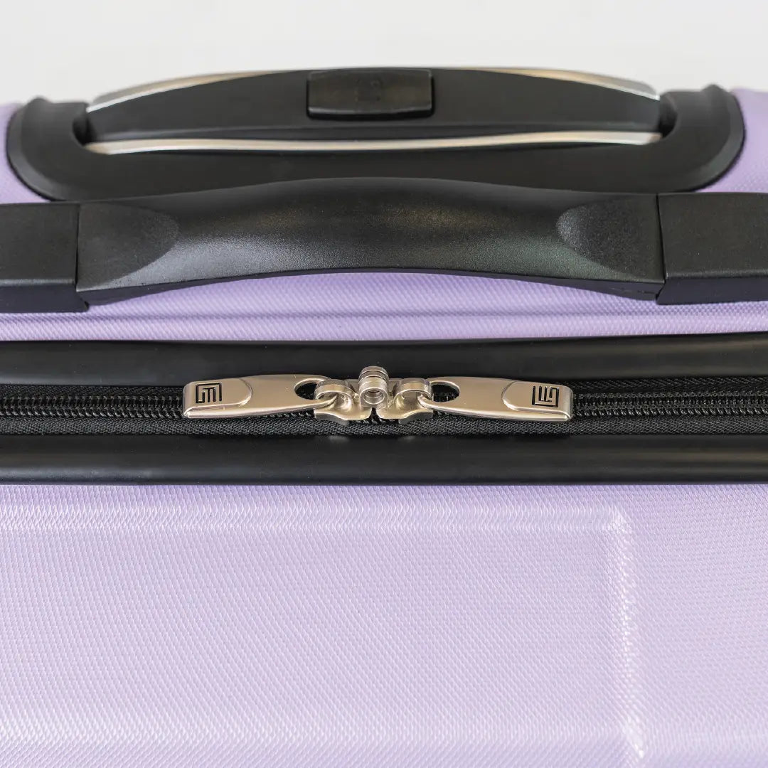 Close-up of a purple suitcase handle and zipper
