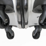 Close-up of a suitcase with wheels on a white background