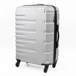 Silver suitcase with black handle and wheels on a white background