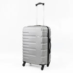 Silver suitcase with black handle and wheels on a white background