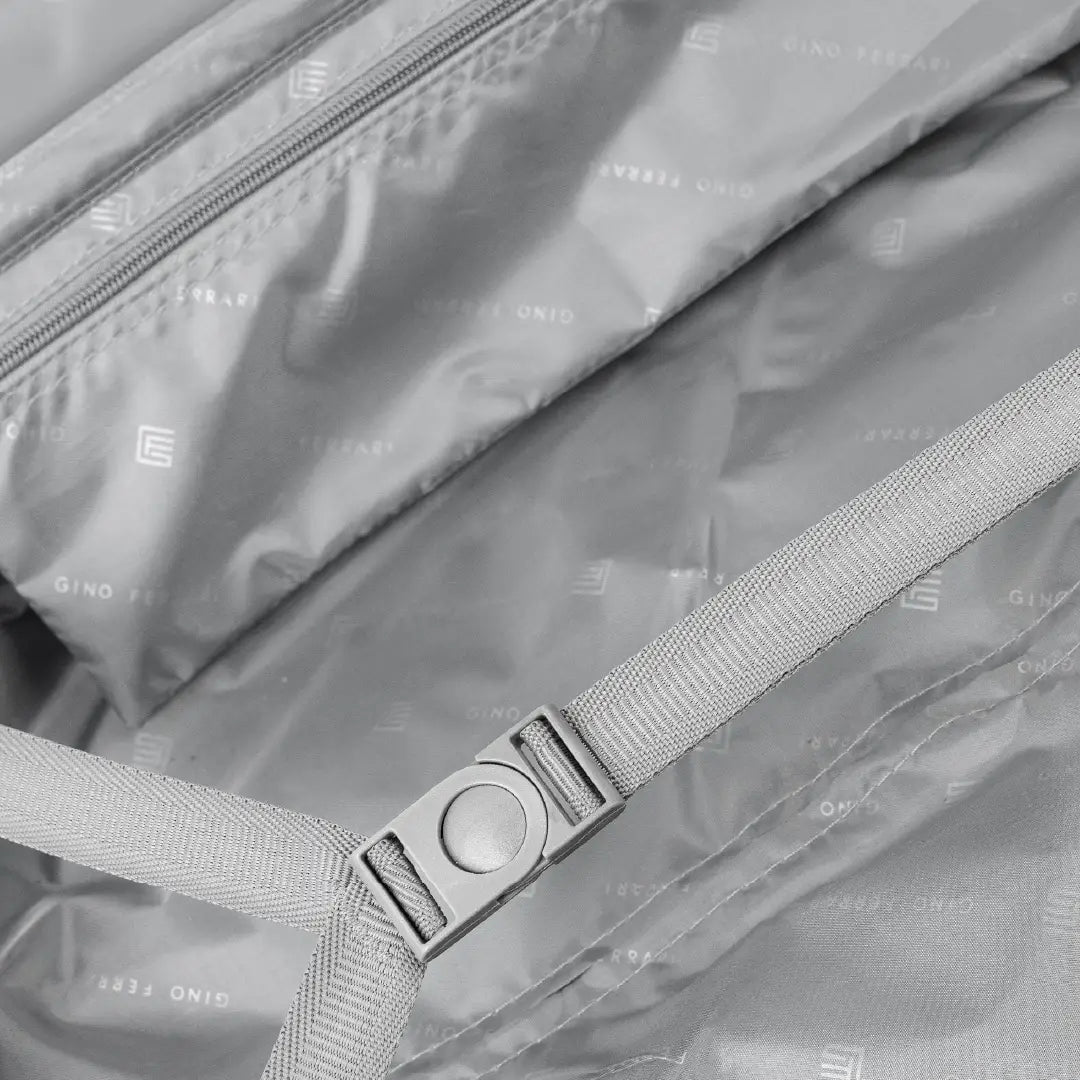 Close-up of a bag with a strap and visible brand logo.