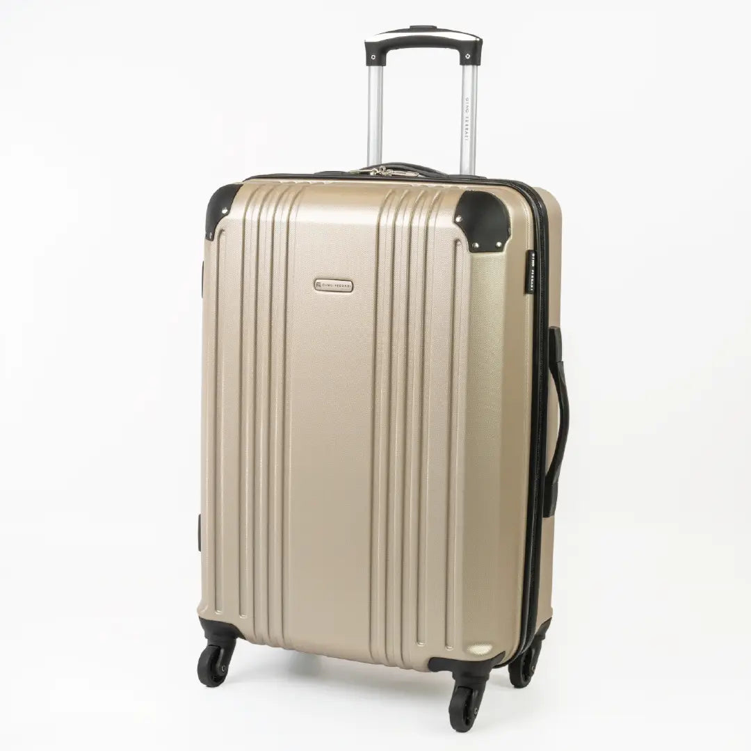 Cabin-sized gold hard-shell suitcase with a visible brand logo and black accents.