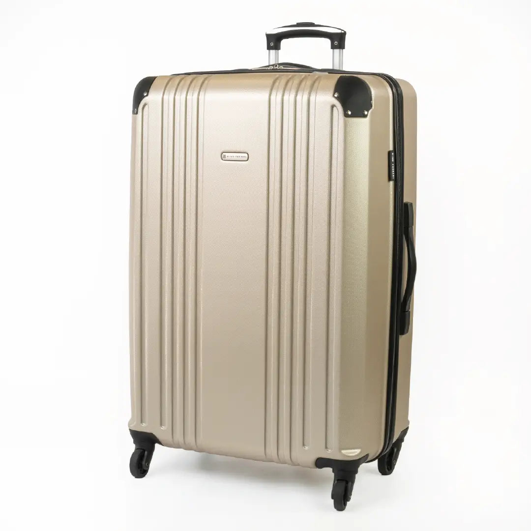 Gold hard-shell suitcase with a visible brand logo and black accents.