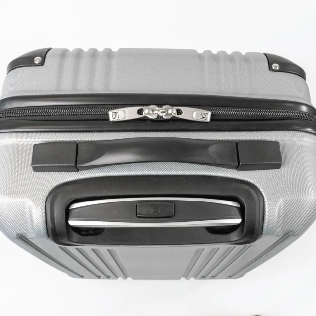 Silver suitcase with black handle and interlocking zip.