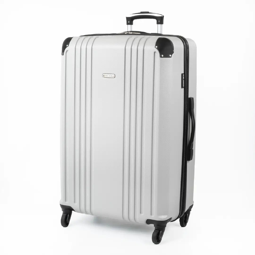 Silver hard-shell suitcase with a visible brand logo and black accents.