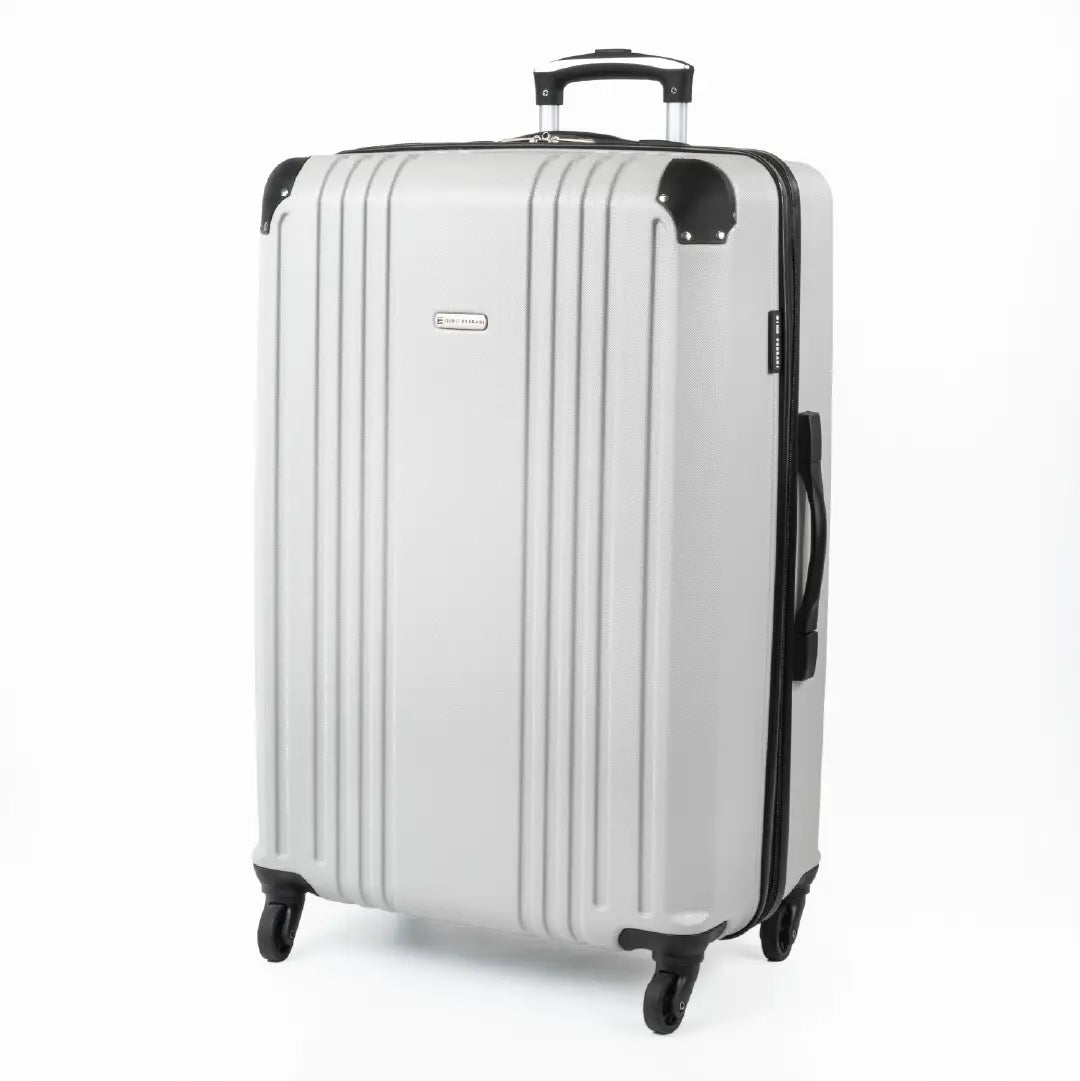 Silver hard-shell suitcase with a visible brand logo and black accents.