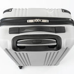 Close-up of a silver hard-shell suitcase with black accents.