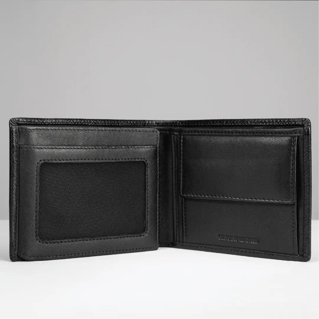 An open black leather bi-fold wallet with multiple card slots, an ID window, and an interior pocket, photographed on a light gray background.